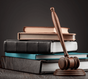 Judge's gavel and pile of books on dark background